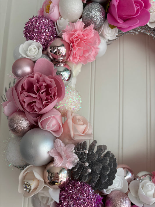 Pink Christmas bauble and floral Wreath.