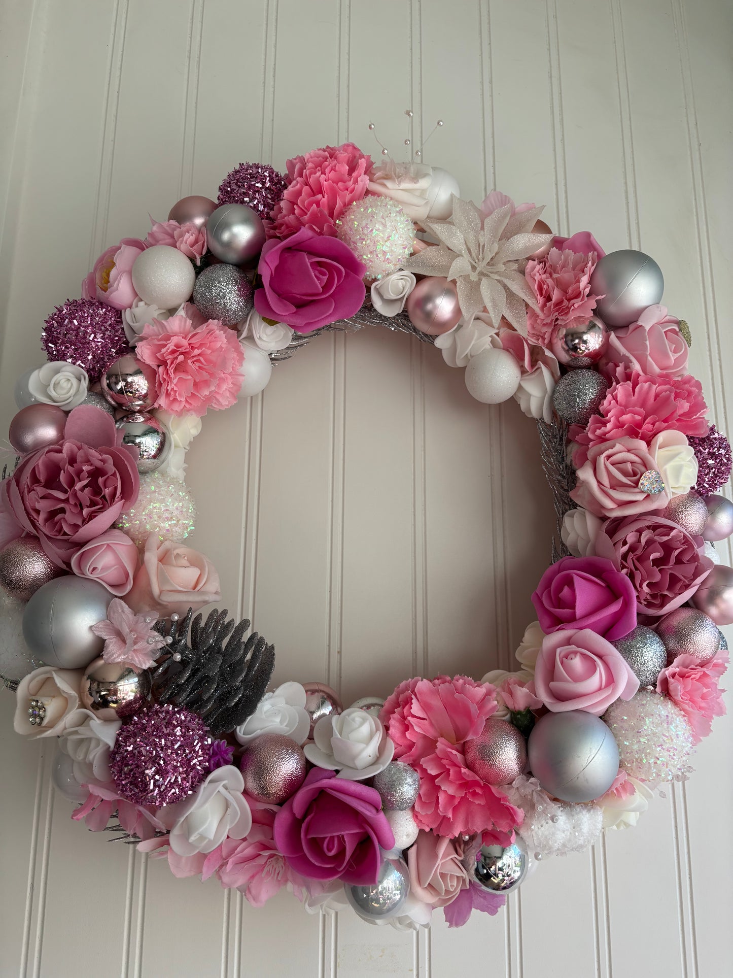 Pink Christmas bauble and floral Wreath.